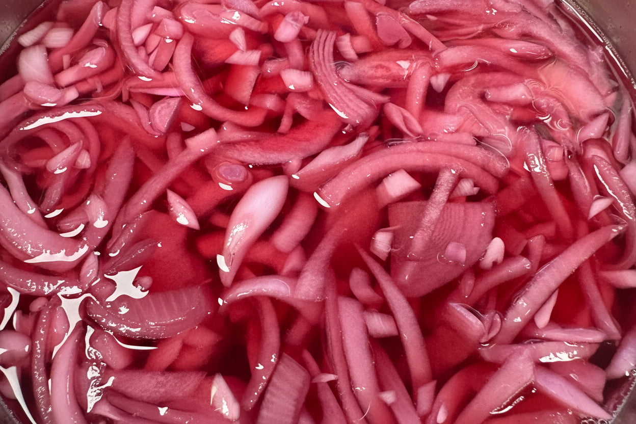 Close-up of pickled red onions in a container