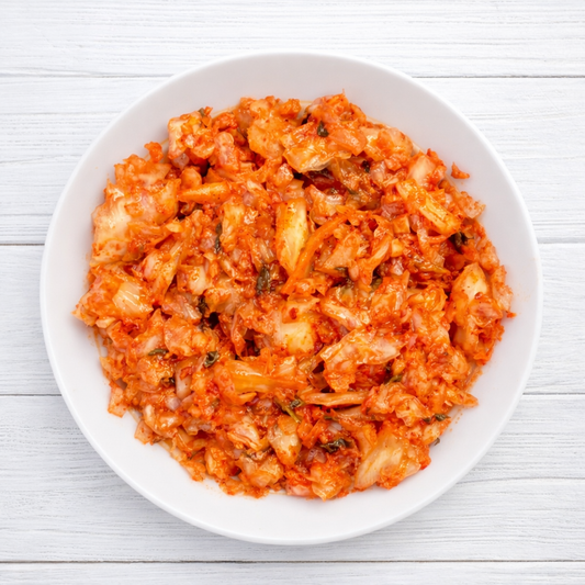 kimchi on a white plate with a white background